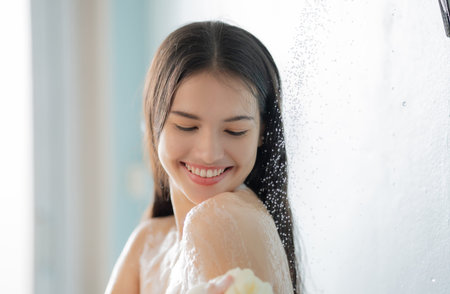 Asian woman She takes a shower and washes her hair in the bathroom