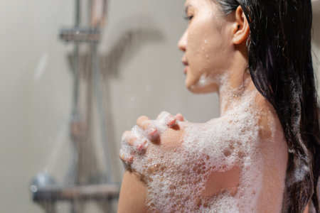 Woman bathing and washing her hair relaxed.の写真素材