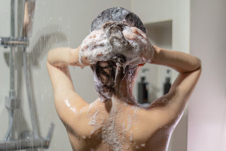 Woman bathing and washing her hair relaxed.の写真素材