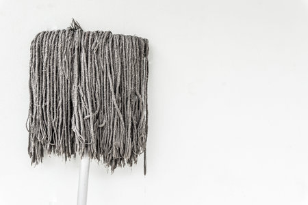 Dirty mop on white wall.の写真素材