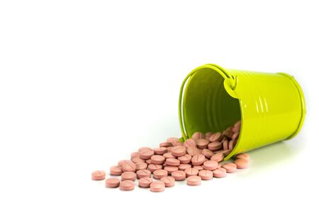 Pills, tablets in green metal bucket on white background.の写真素材