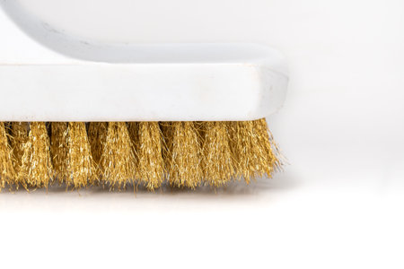 Wire Scratch Brush, Brass with Plastic Handle on white background.