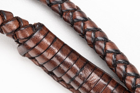 handcrafted leather rope on white background with selective focus