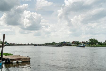 small blue boat on the river with sky and cloud.の写真素材