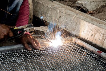 worker used electric welding wire mesh to make bird cage.の写真素材