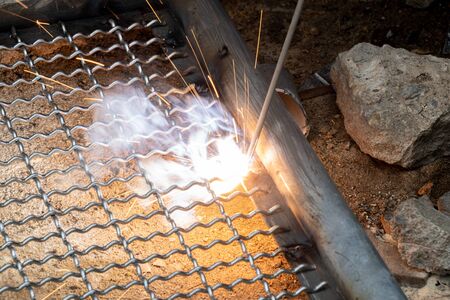 worker used electric welding wire mesh to make bird cage.の写真素材