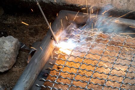 worker used electric welding wire mesh to make bird cage.の写真素材