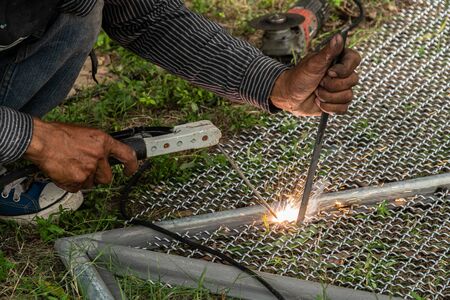 worker used electric welding wire mesh to make bird cage.の写真素材