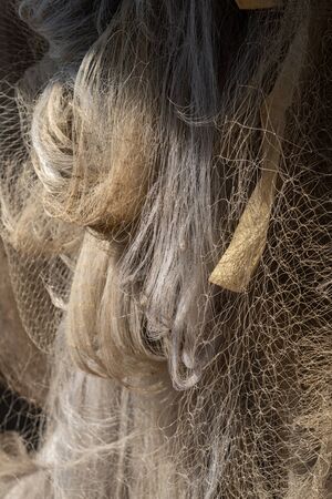 Many size of fishing nets hanging in the sun for dry after use.の写真素材