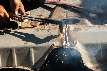 Oxy-Fuel Cutting Torch to cutting car for metal recyclingの写真素材
