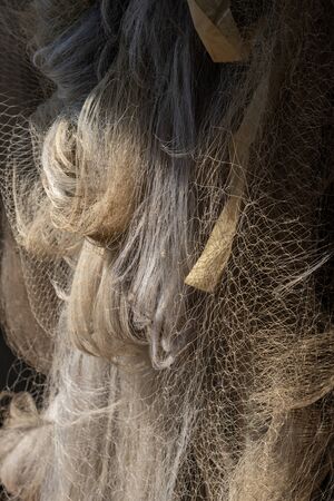Many size of fishing nets hanging in the sun for dry after use.の写真素材