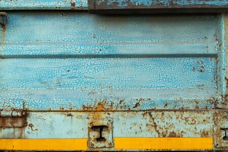 Close-up, the surface tuxture of the truck's metal panel is full of rustの写真素材