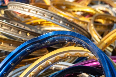 stack of multi color and size of aluminium motorcycle rims for recycling. Aluminum alloy bike wheels for recycling.の写真素材