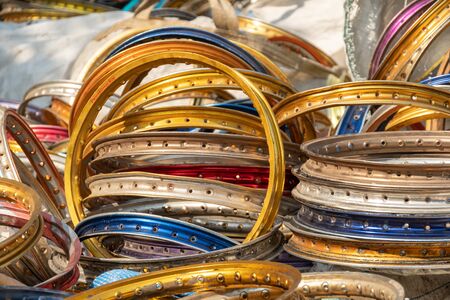 stack of multi color and size of aluminium motorcycle rims for recycling. Aluminum alloy bike wheels for recycling.の写真素材