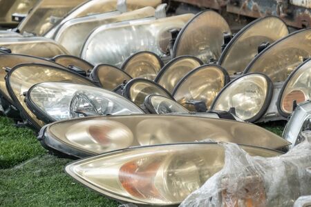 Used headlamp components for sale at scrapyard areaの写真素材