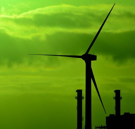 Wind turbine and chimneys of power station, colored imageの写真素材