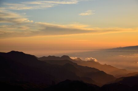 Silhouettes of mountains at sunset, from summit of Gran canaria, Canary islandsの写真素材