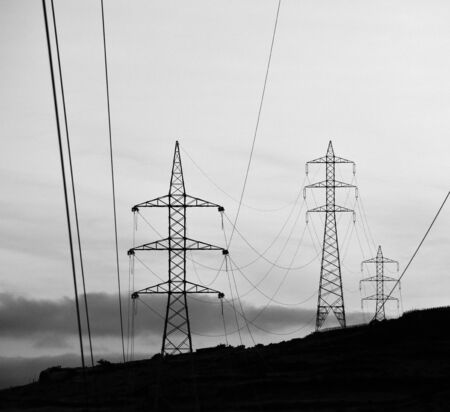 Hanging cables and electric towers, lines and shapes, monochrome effectの写真素材