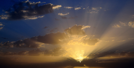 Stunning sky during sunrise, scattered clouds and multiple sunbeamsの写真素材