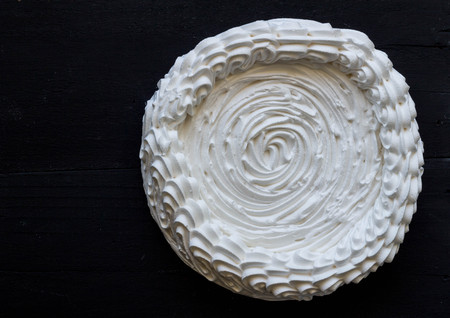 Meringue unfilled on black background - Large meringue top view photoの写真素材