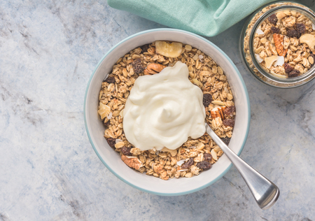 Granola with yogurt served for breakfast - top view photo with copy spaceの写真素材