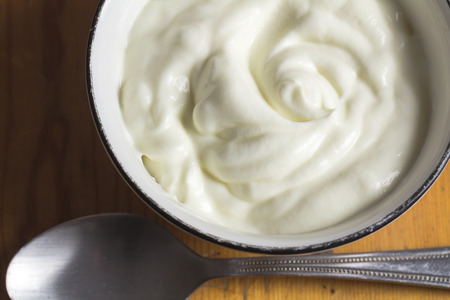 Yogurt in small bowl, natural creamy white greek yogurt close up - Top view photoの写真素材