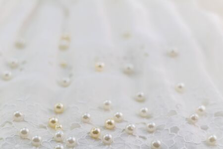 Pearls on lace with selective focus - abstract pearl background with space for textの写真素材