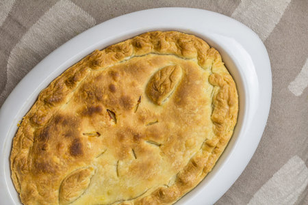 Top view of baked shortcrust pastry pie - rustic homemade pie crust background with copy space