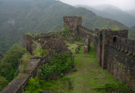 Interior of MagliÄ castle (built in 13th century by Stefan UroÅ¡ I) on a foggy day. View from a gateのeditorial素材