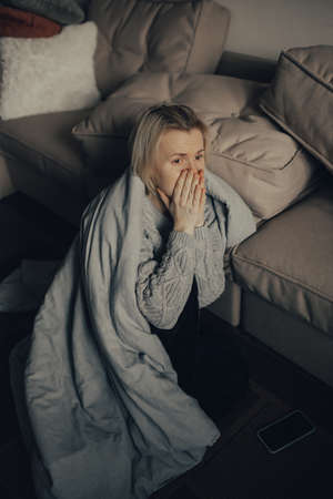 The woman is afraid of the sounds of air raids and explosions. The concept of fear and sadness. stop the war. Pray for Ukraine. we are available to Ukraine.の写真素材