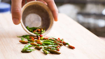 Pour chillies on a board.の写真素材