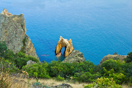  The rock arch in the sea cliffs of whimsical form  