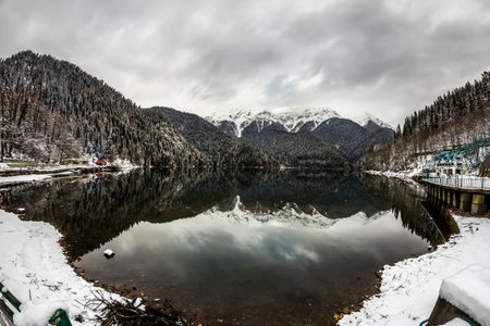 Alpine Lake Ritsa in winter under gloomy clouds, Abkhaziaの写真素材
