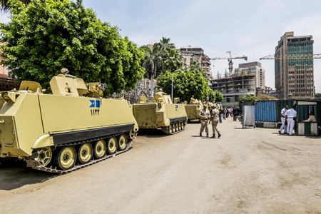 Armoured vehicles and soldiers in front of the burned-out buildings of the Government and the National Museum in Cairo, April 13, 2014,Egyptのeditorial素材
