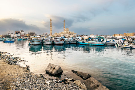 Yachts berthed at the port of Hurghada, Hurghada Marina at sunset against the mosque, April 15,...