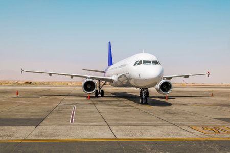The plane is on the runway at the airport runway on a sunny day