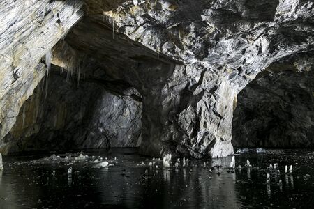 Cave with a frozen lake in the marble quarry Ruskeala in Karelia in the winter. Russiaの写真素材