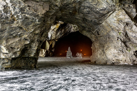 Cave with a frozen lake in the marble quarry Ruskeala in Karelia in the winter. Russia