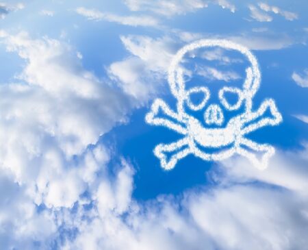 the blue sky with the symbol of the skull and bones from the cloudの写真素材