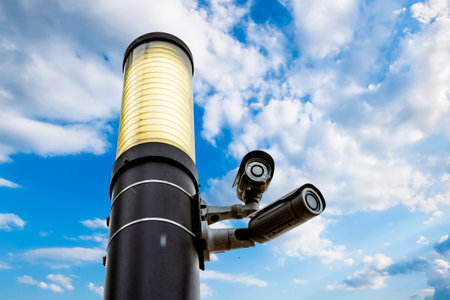Surveillance cameras on the streets of the city against the blue sky