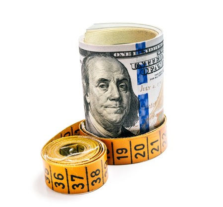 bundle of dollars belted measuring tape isolated on white backgroundの写真素材