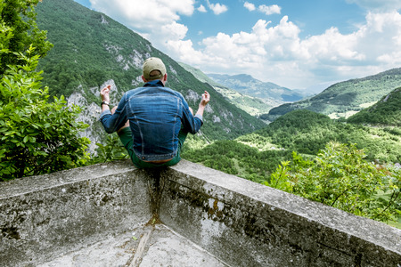man in a lotus position meditating above the canyon of the river Taraの写真素材