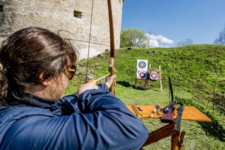02 may 2016. Staraya Ladoga.Girl shoots arrows from the walls of the fortress in Staraya Ladoga.Russia.の写真素材