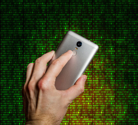 Finger touches the fingerprint scanner on the smartphone in the background of the digits of the...