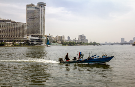 Cairo. Egypt.April 13, 2014.Sailboats on the Nile in Cairo in Egypt against the backdrop of buildingsのeditorial素材
