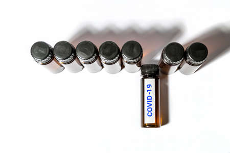 medical test tube with the inscription covid-19 among other test tubes on a white backgroundの写真素材