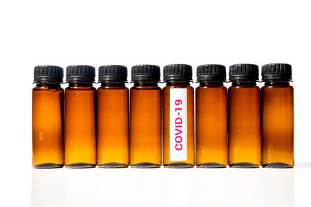 medical test tube with the inscription covid-19 among other test tubes on a white backgroundの写真素材