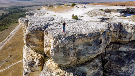 White Rock Ak Kaya.Crimea.10 september 2021.Girl poses standing at the edge on top of the White Rock Ak Kaya on the Crimea.のeditorial素材
