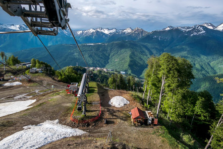 sochi. Russia. 2 june 2022. Cable car cabin rises up from Rosa Khutor village to Roza Peak mountain...
