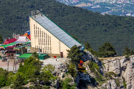 Yalta. Crimea. May 28, 2021.Cable car with yellow trailers at the top of Mount Ai Petriのeditorial素材